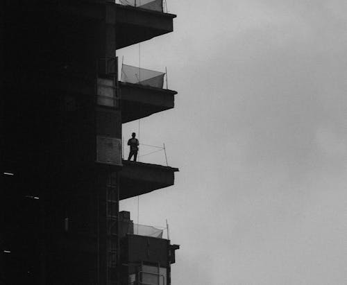 Black and White Photo of a Man in a Building