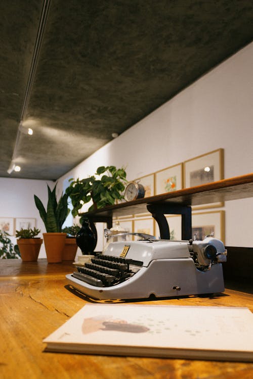 Gray Typewriter on Wooden Table