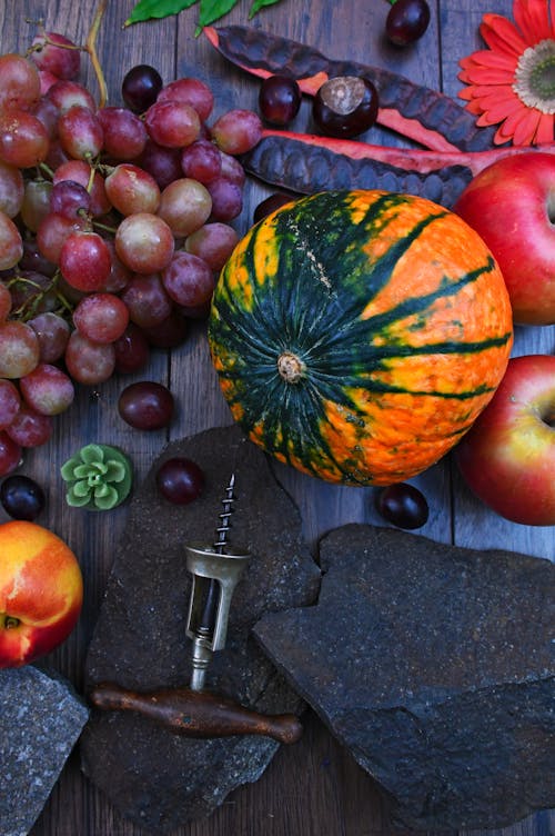 Orange Pumpkin Near Apples and Grapes