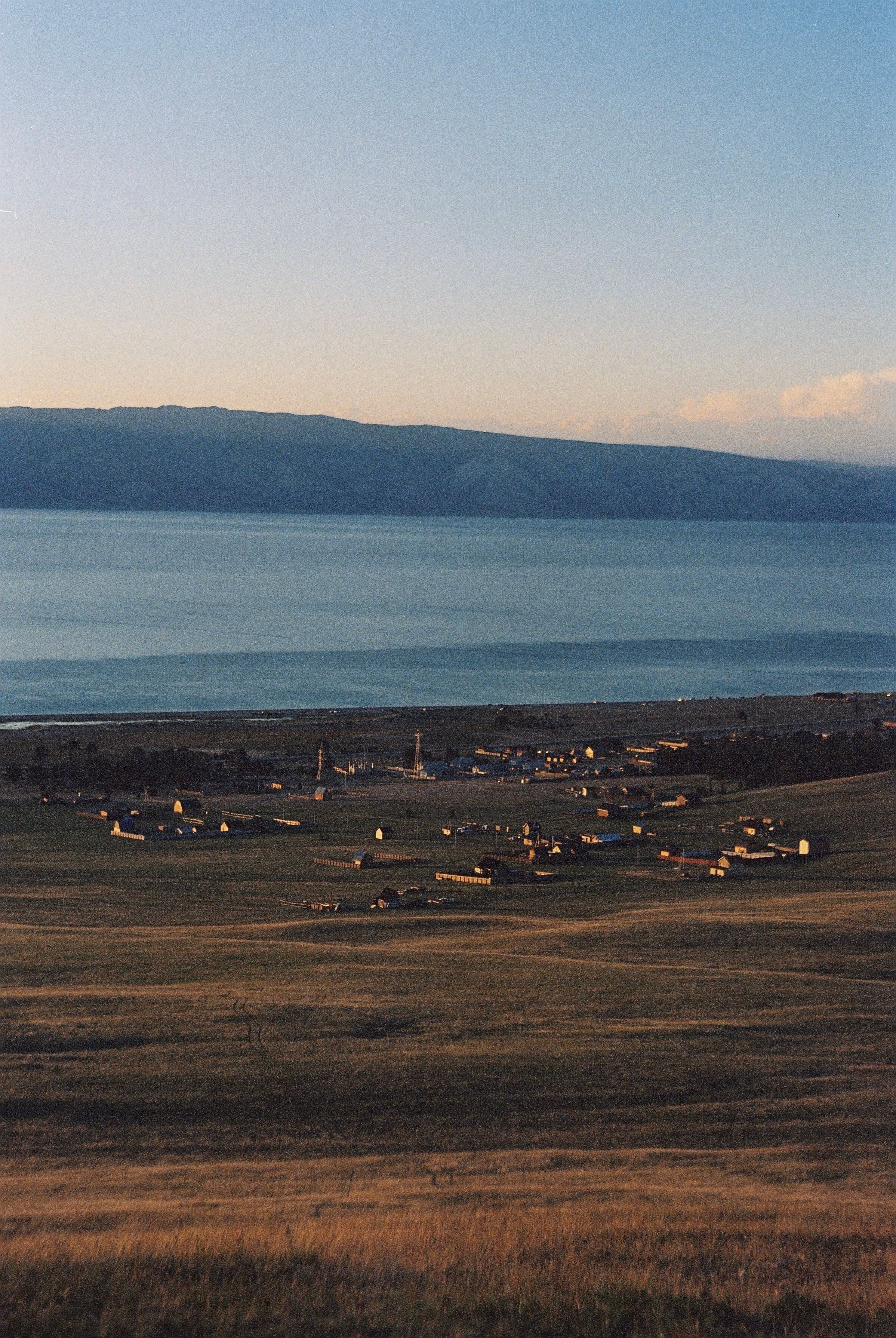 Stunning landscape of Lake Baikal and rural village in Irkutsk Oblast, Russia.