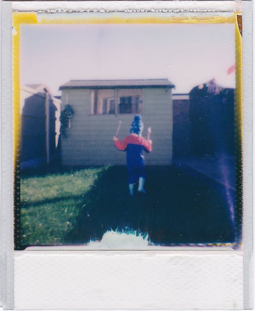 Polaroid Picture of a Child Playing in the Garden 