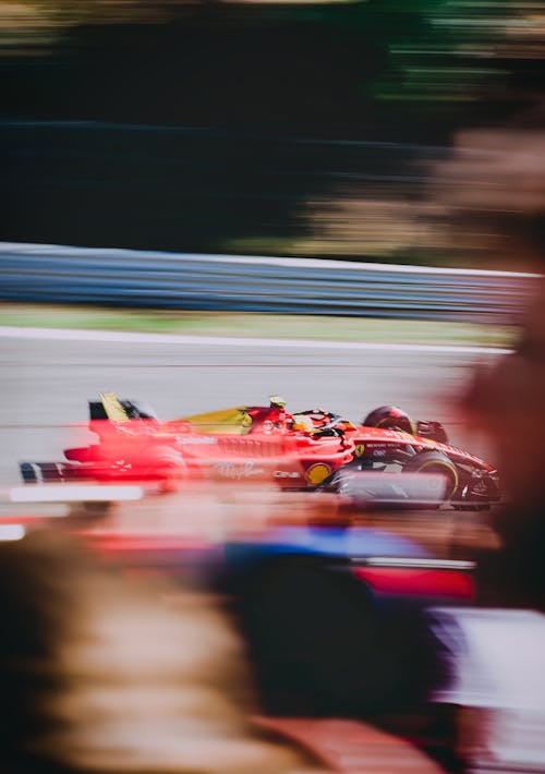 Red Formula One Car Dashing on a Racing Circuit