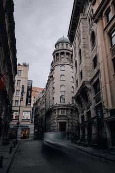 Overcast day on an empty European street showcasing historic architecture.