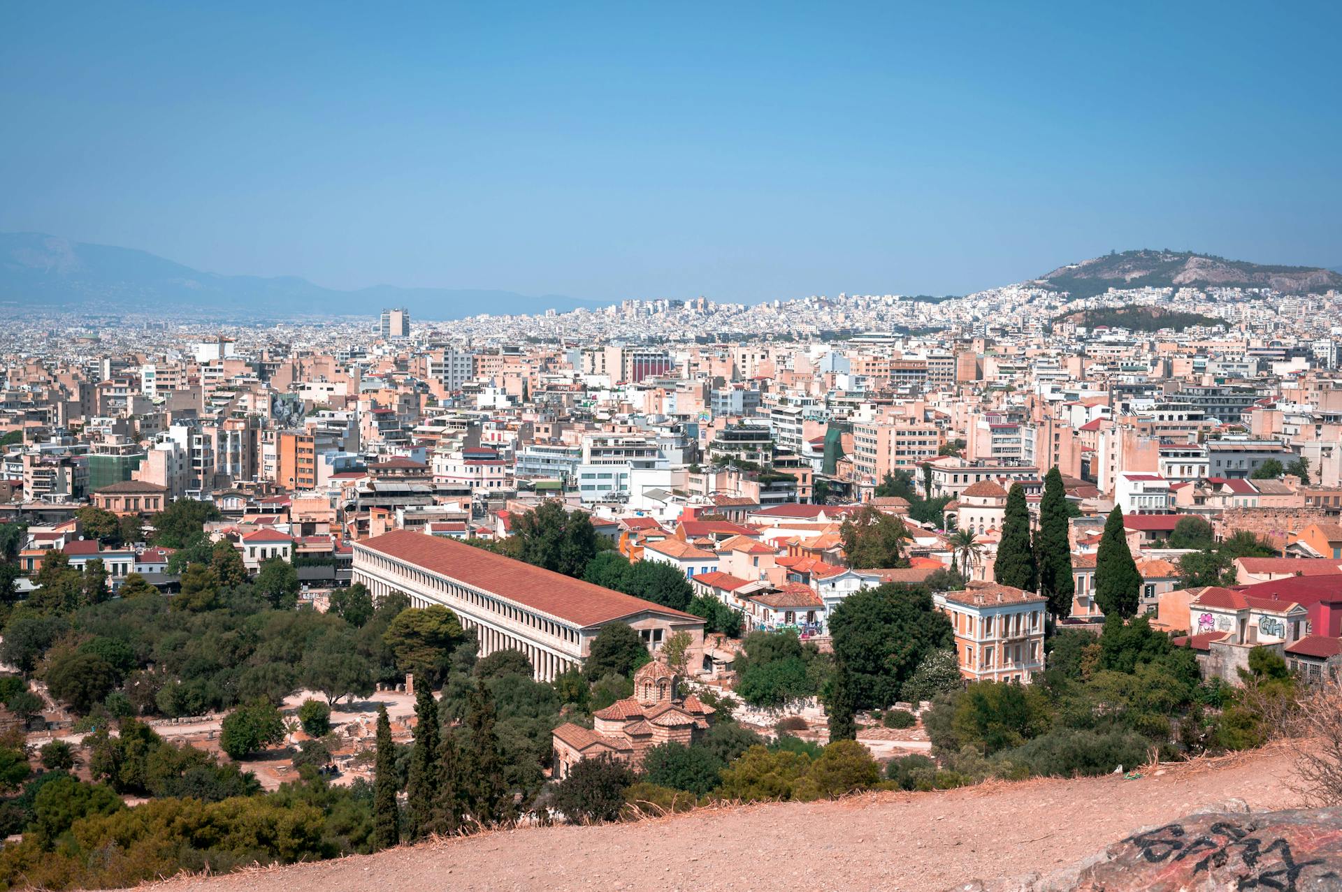A breathtaking aerial view of Athens cityscape showcasing ancient landmarks and modern architecture.