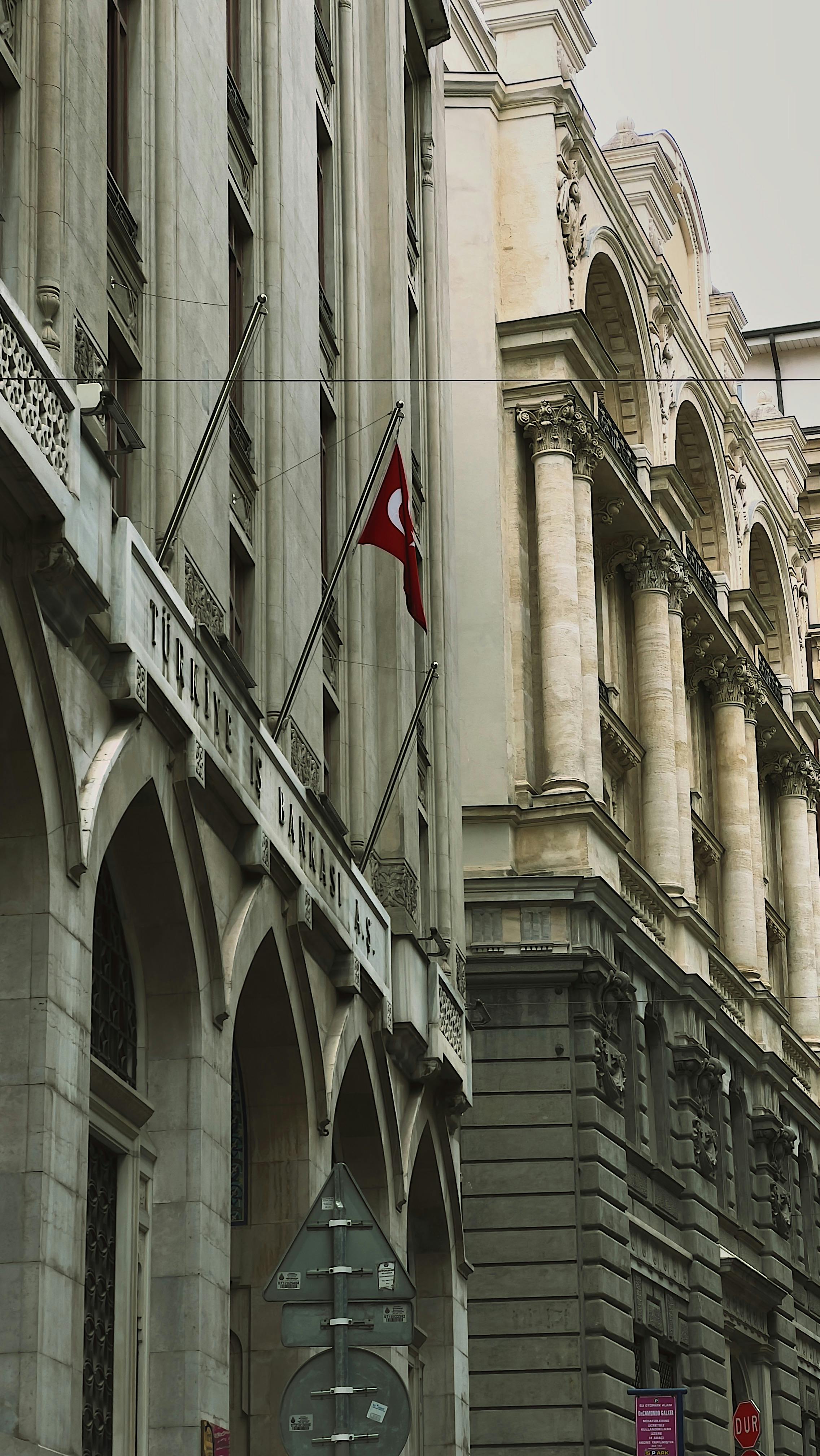 A vintage building in Istanbul showcasing Ottoman architecture with a Turkish flag.