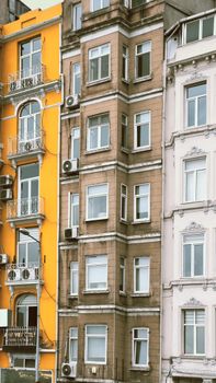 Vibrant architectural facades of city buildings showcasing diverse colors and designs.