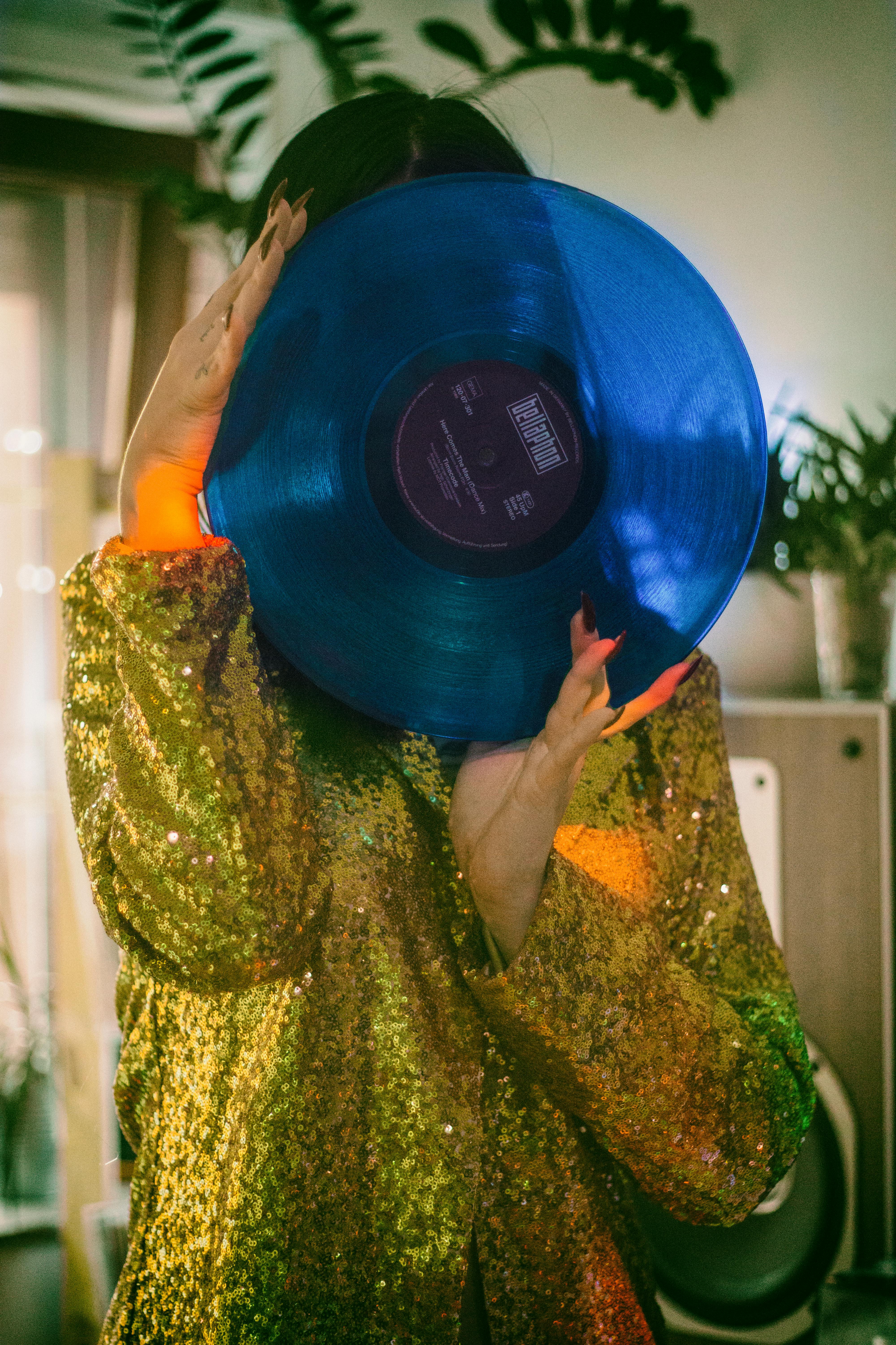 woman holding blue vinyl record