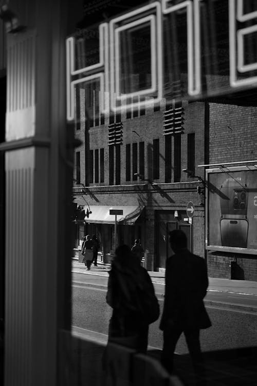 Grayscale Photography of People Walking on Sidewalk