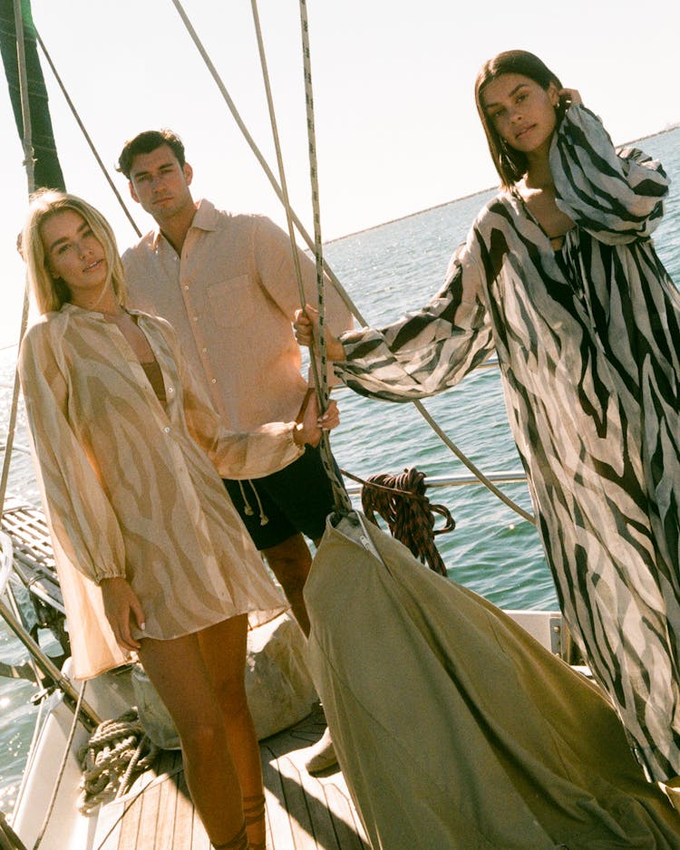 A Man And Women Standing On Boat