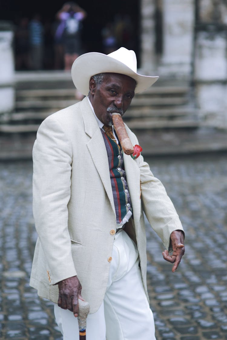 Man In White Suit And Cowboy Smoking Tobacco