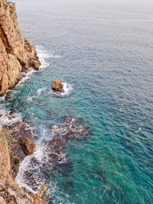 Waves Crashing against Eroded Cliff