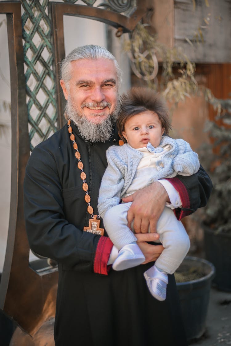 Priest Holding Baby