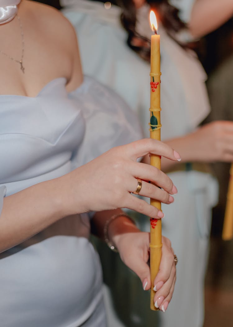 A Person Holding A Lighted Candle