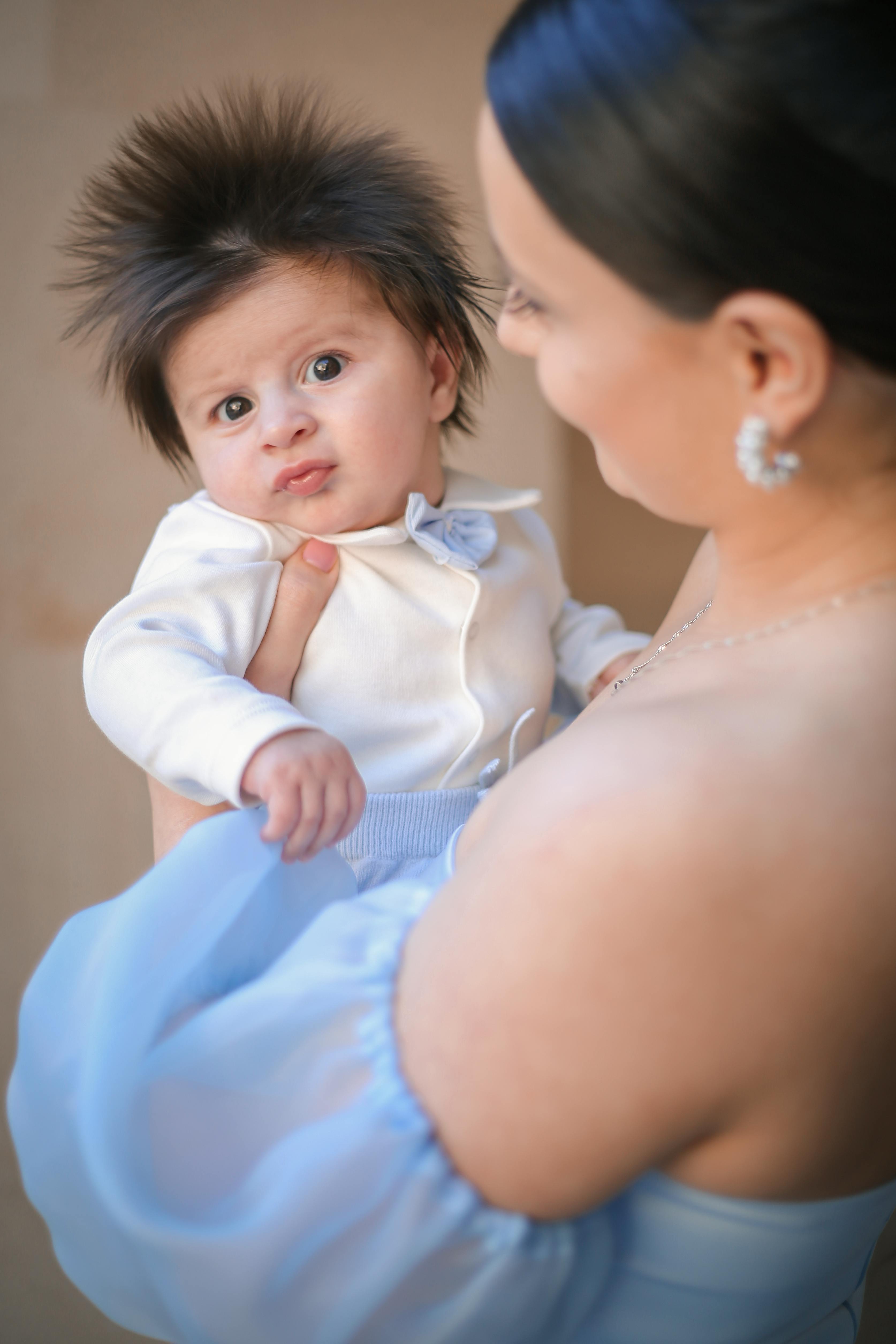 portrait-of-baby-in-mothers-arms-free-stock-photo