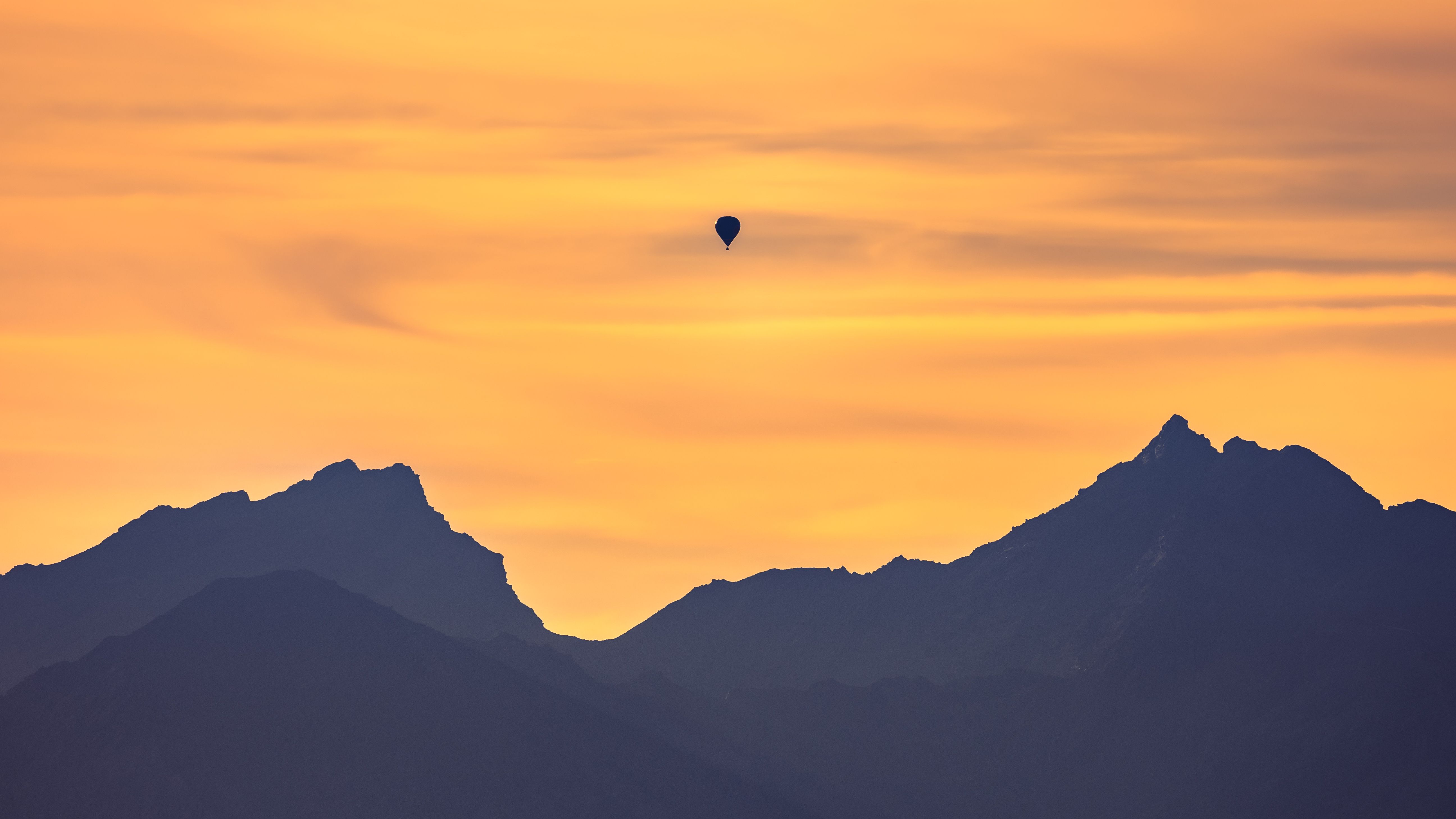 Hot Air Balloon Flying over the Mountains during Sunset · Free Stock Photo