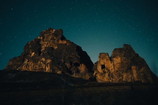 A stunning view of rock formations under a starry night sky.