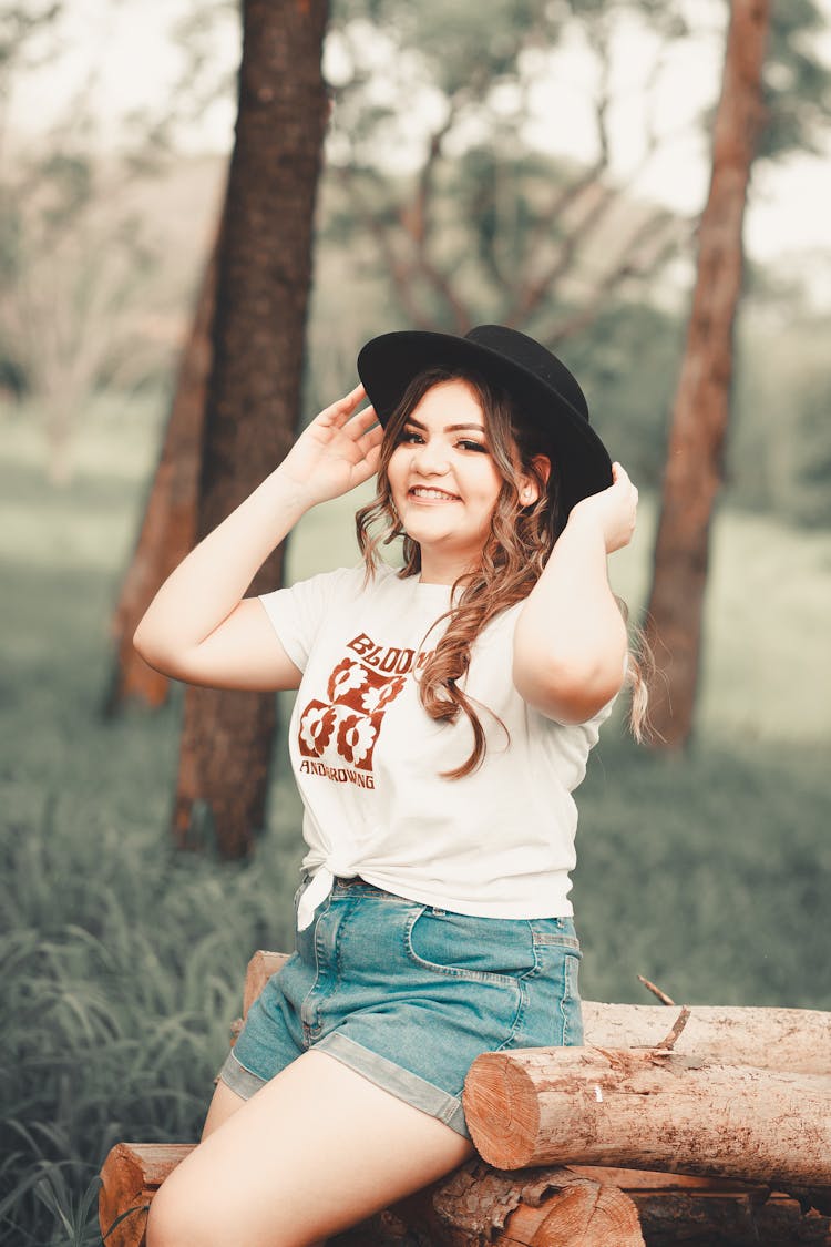 Smiling Woman Holding Her Black Hat