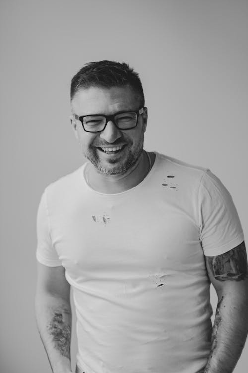 Grayscale Photo of a Man Smiling