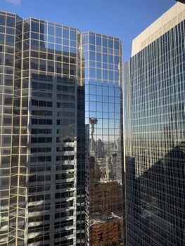 Stunning view of Calgary's modern skyscrapers reflecting the city skyline under a clear blue sky.