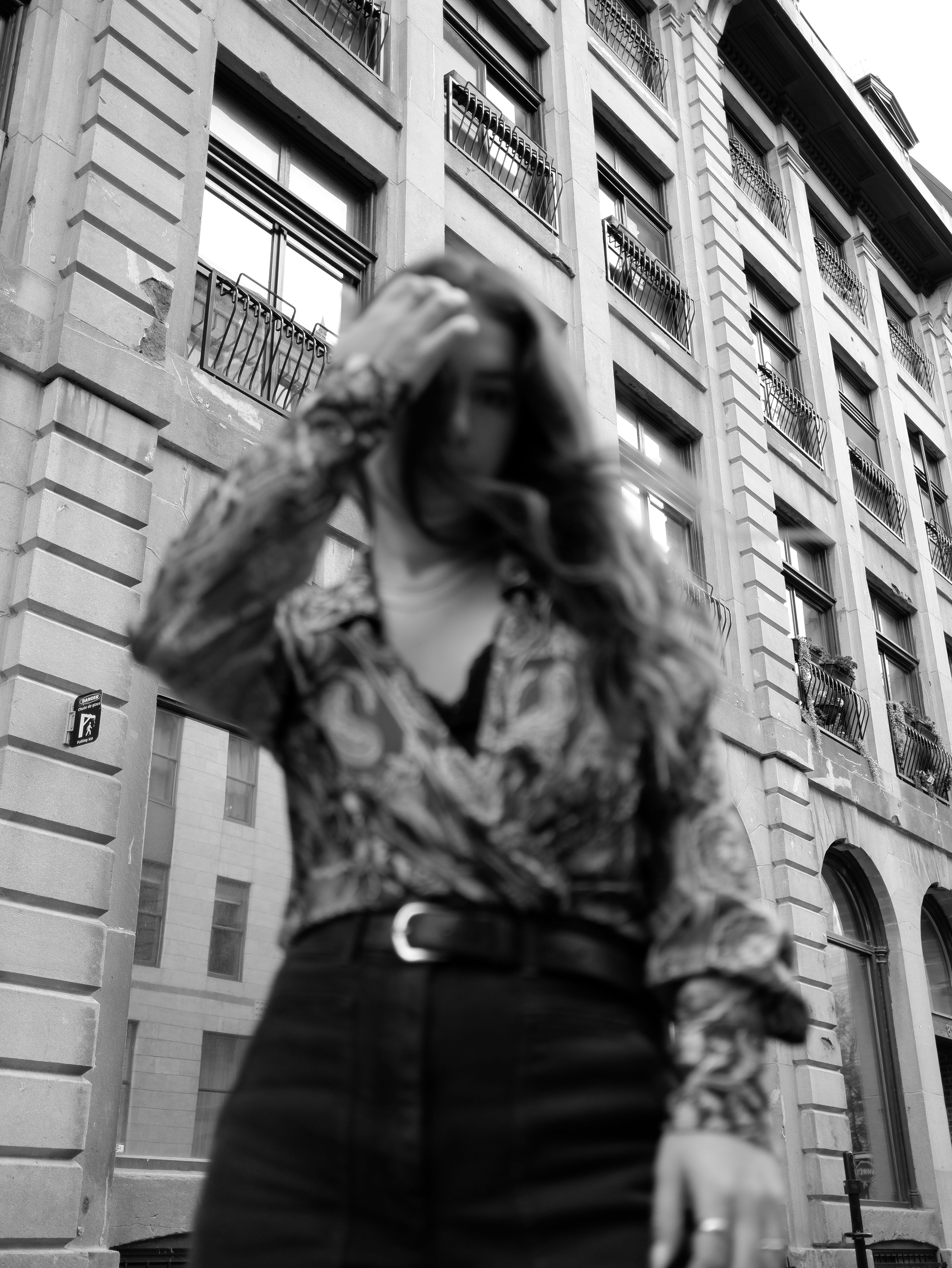 Stylish portrait of a woman against a building facade in Montréal, QC, Canada.