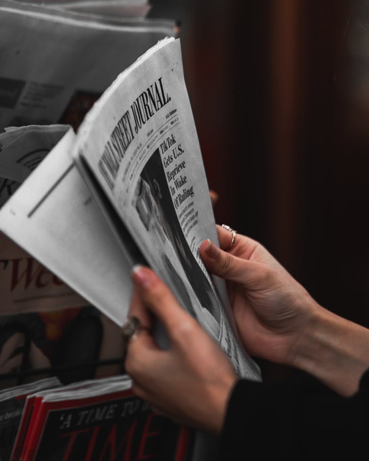 A Person Holding A Newspaper 