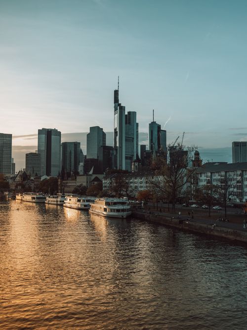 Free Skyline of Frankfurt with skyscrapers reflecting in the River Main at sunset. Stock Photo