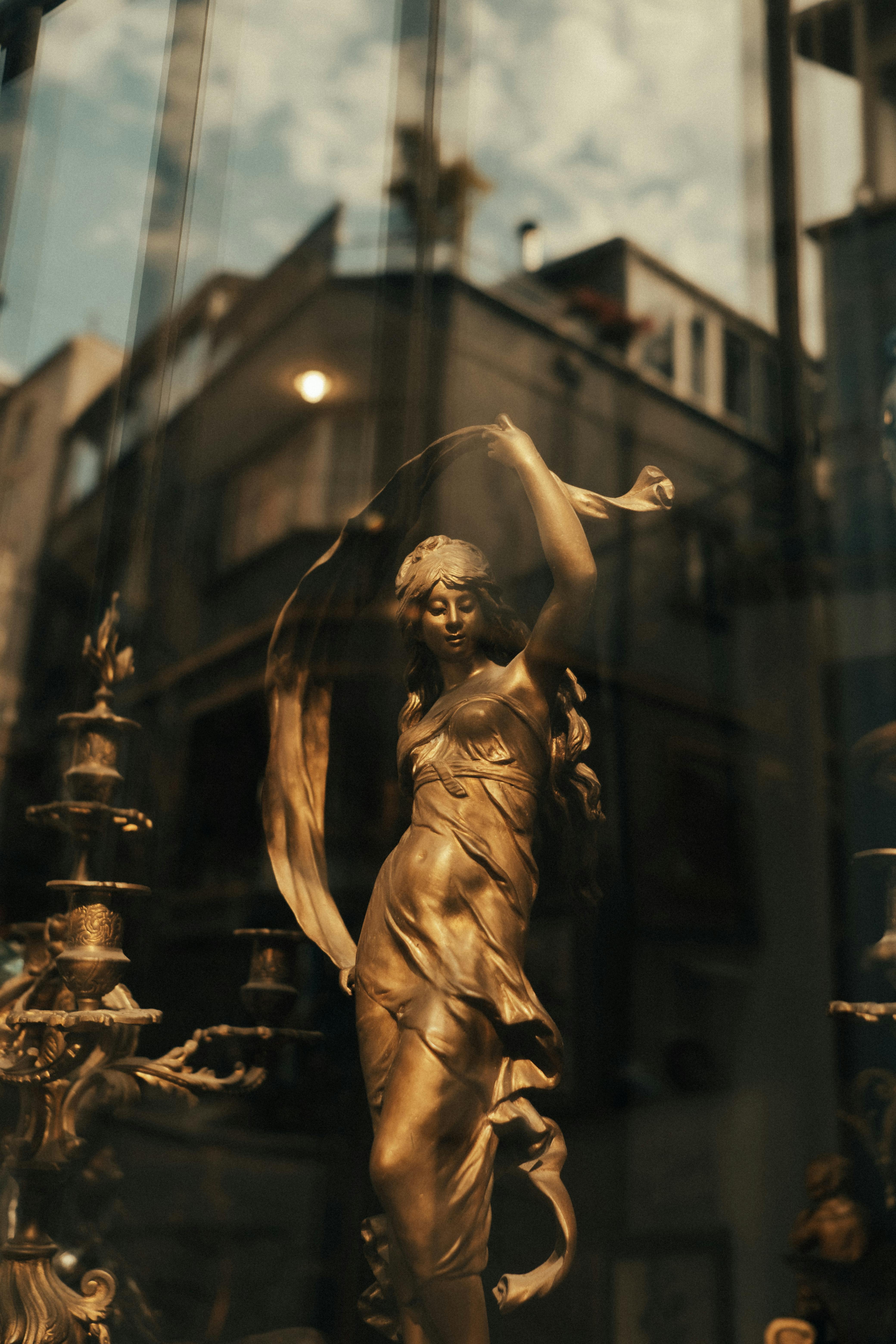 A beautiful golden statue in an urban setting reflecting sophistication and art.