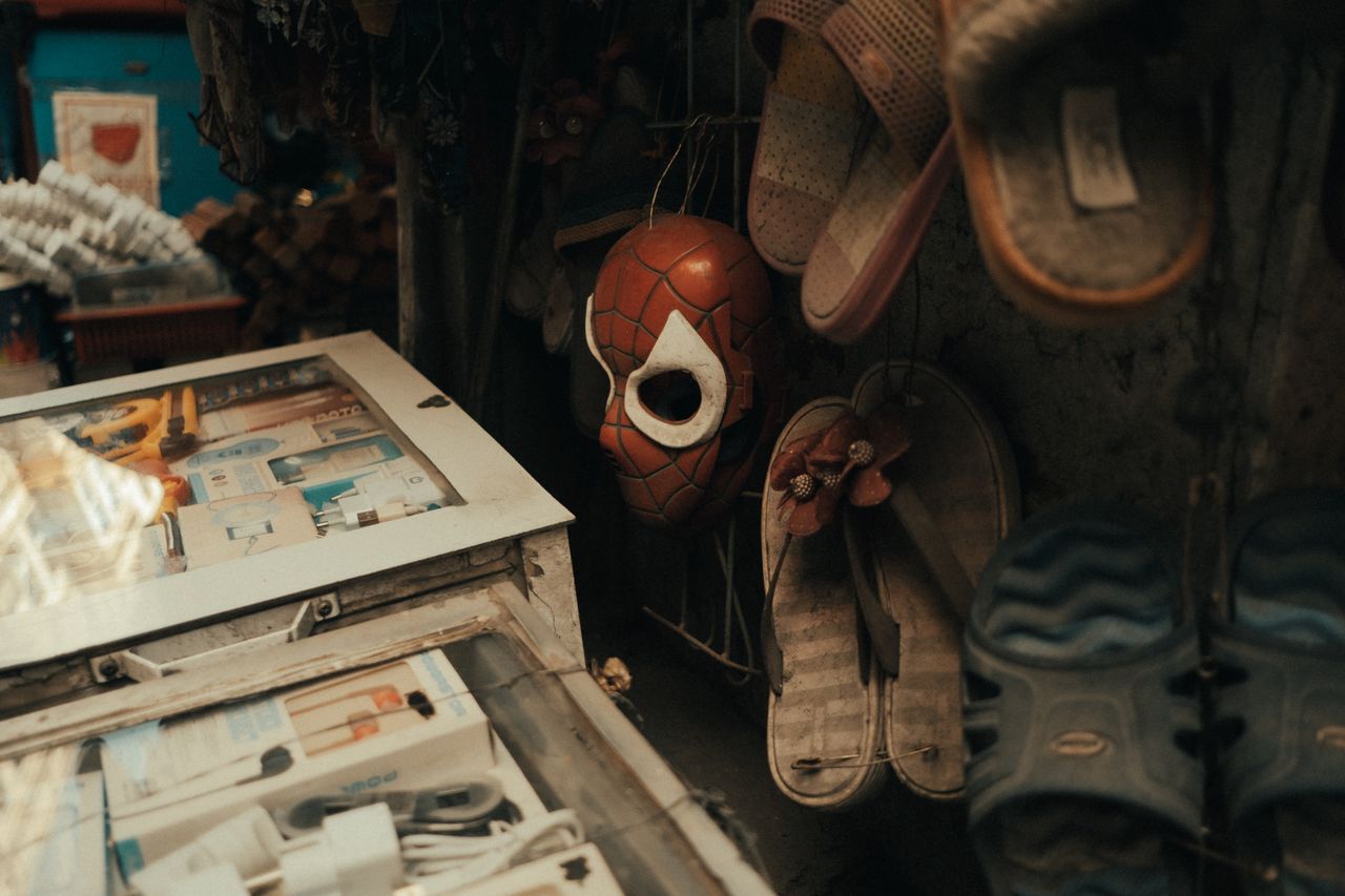 close up view of a shop display featuring a spider man mask among vari