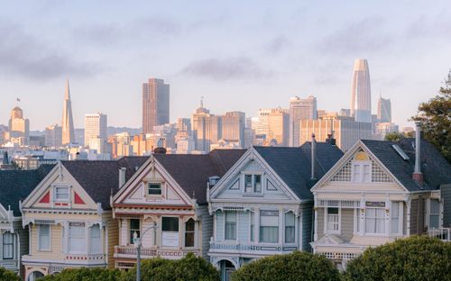 Free Victorian Painted Ladies and San Francisco skyline during sunrise. Stock Photo