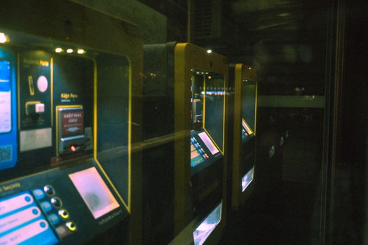Dark Photo of Illuminated Ticket Machines