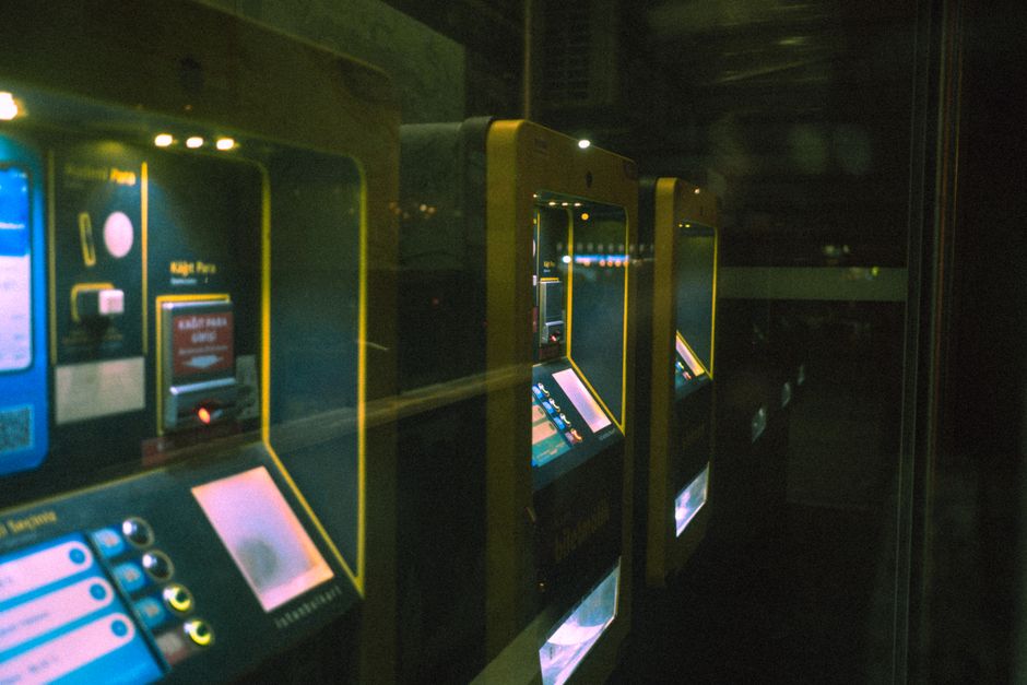 Illuminated PulseScreen kiosks in a dark venue