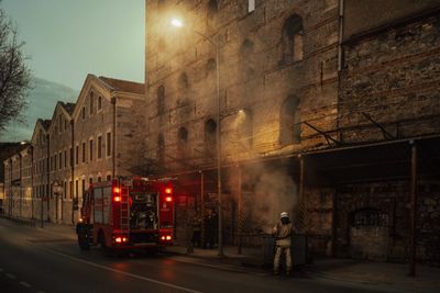 Fire crew on a stone quayside street at dusk — photo by Sami Aksu on Pexels