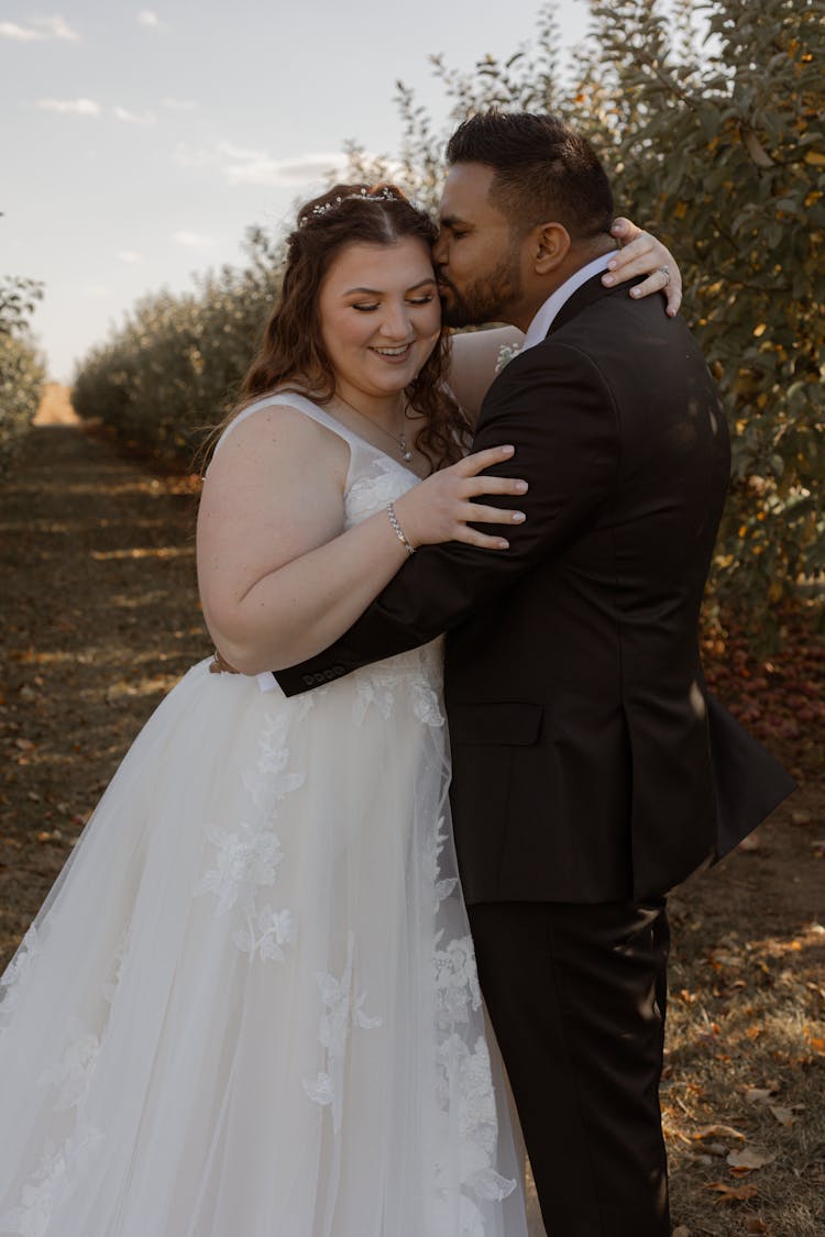 A Groom Kissing The Bride 