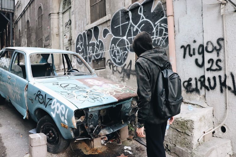 Man Standing In Front Of A Demolished Car 