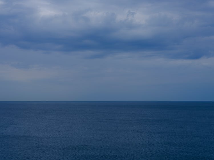 Calm Water In The Ocean Under Blue Sky