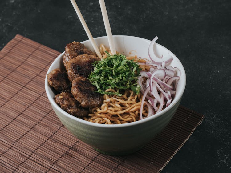 Chopsticks And Meal In Bowl