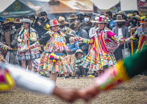 Women in Traditional Clothing Dancing at a Festival 