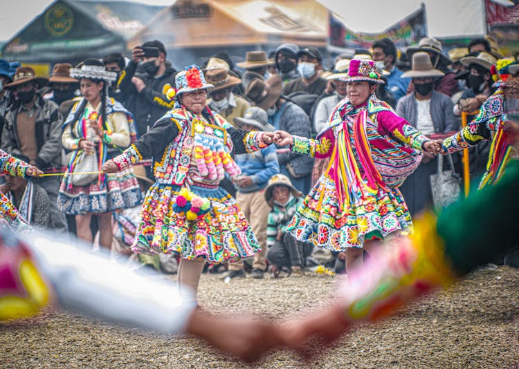 Women In Traditional Clothing Dancing At A Festival 