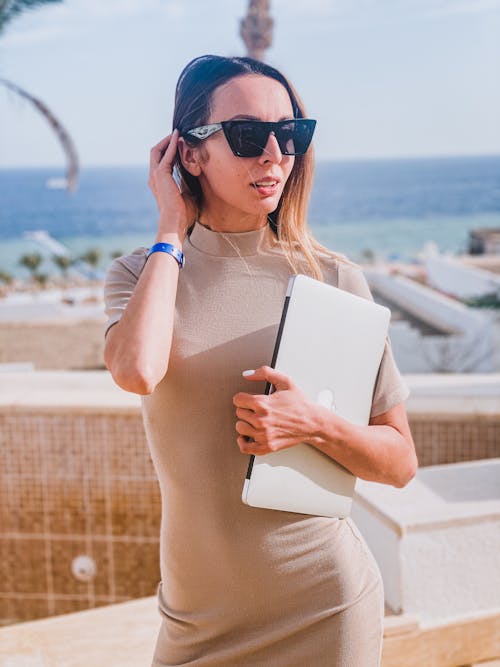 Portrait of Woman in Sunglasses and with Laptop