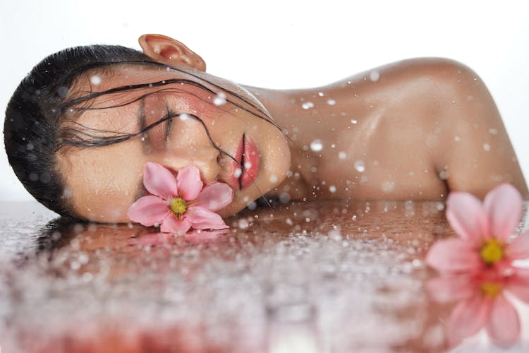Photo Of A Woman With A Wet Face Next To Flowers 