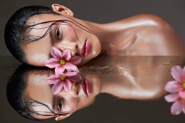 Woman With A Flower On Her Eye Reflecting In A Mirror 