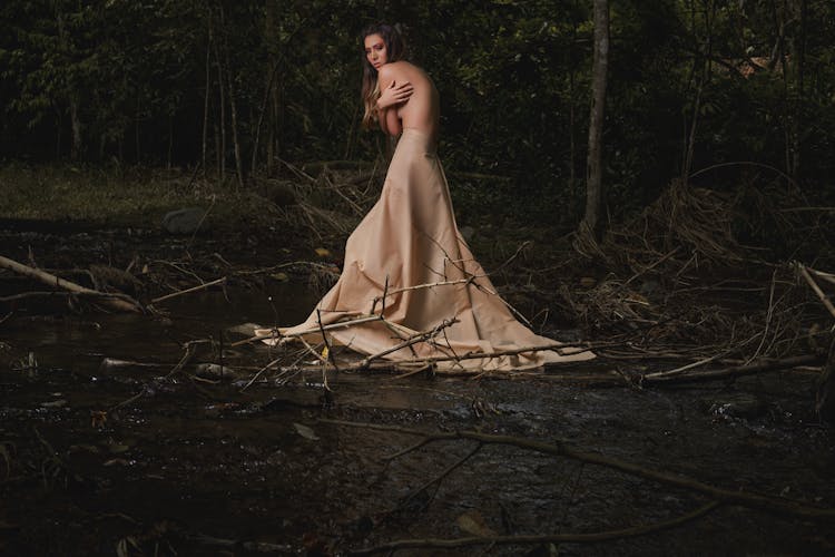 Shirtless Woman Standing In A Forest 