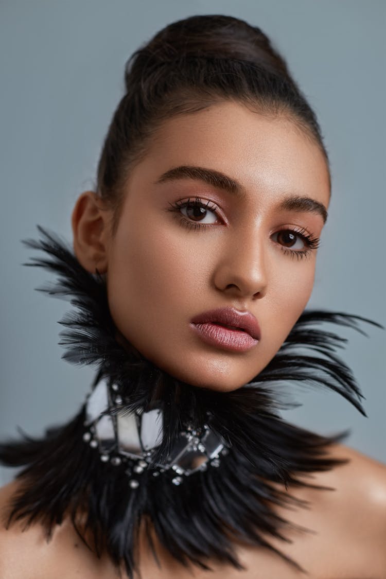 Woman Wearing A Collar Made From Feathers 