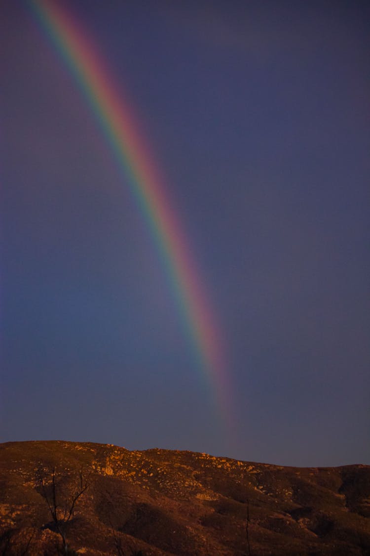 View Of A Rainbow Under The Blue Sky