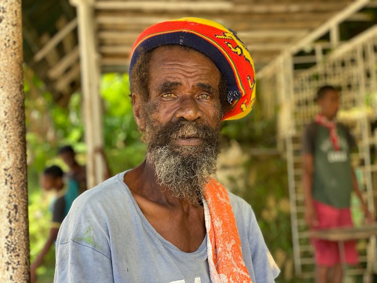 Elderly Rasta Man With Facial Hair Wearing A Rasta Tam Hat