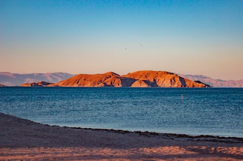 Free Stunning beach view at Bahía de los Ángeles with serene sea and island landscape under a clear sky. Stock Photo