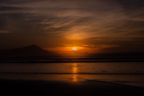 Free Breathtaking view of a sunset over an ocean in Ensenada, capturing nature's beauty and serene atmosphere. Stock Photo