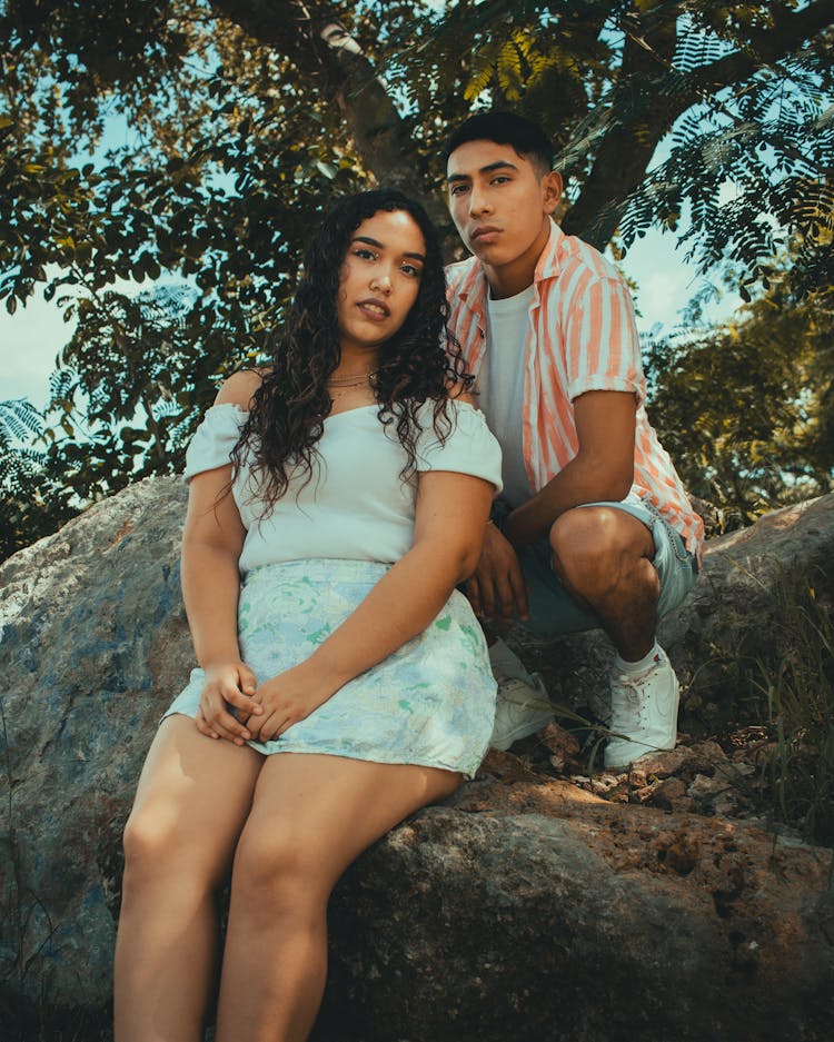 Beautiful Couple Sitting On A Big Rock