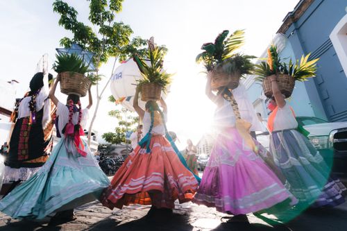 Free Women in vibrant dresses at a street festival in Oaxaca, Mexico, showcasing cultural heritage. Stock Photo