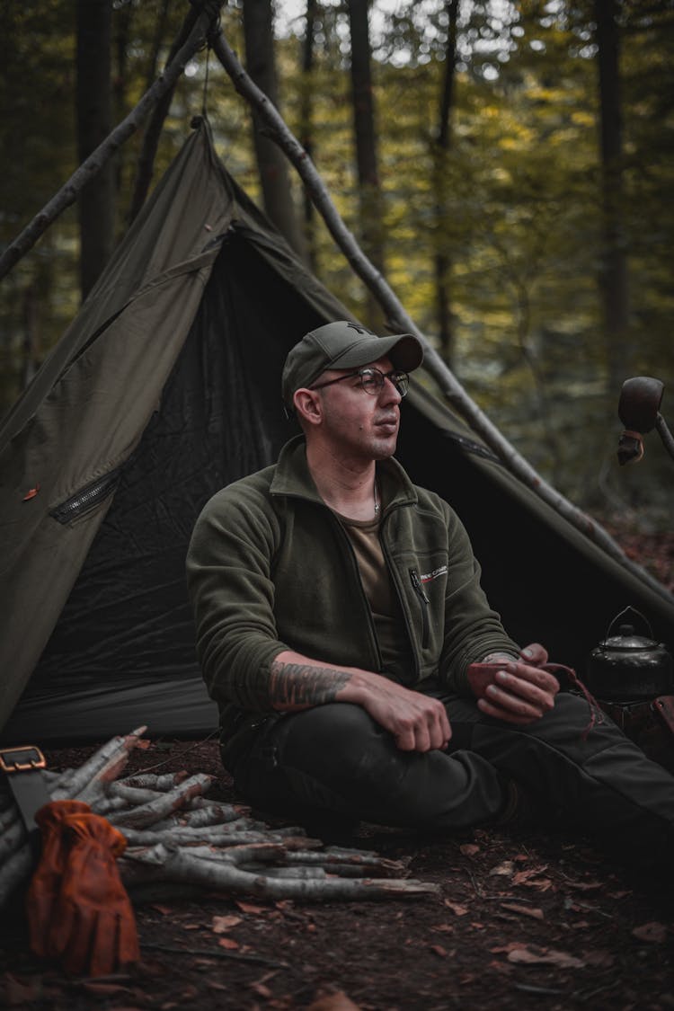 Man Sitting By A Tent 